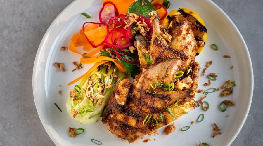 XO partridge with charred bok choy, tangy pickled vegetables and crispy onions
